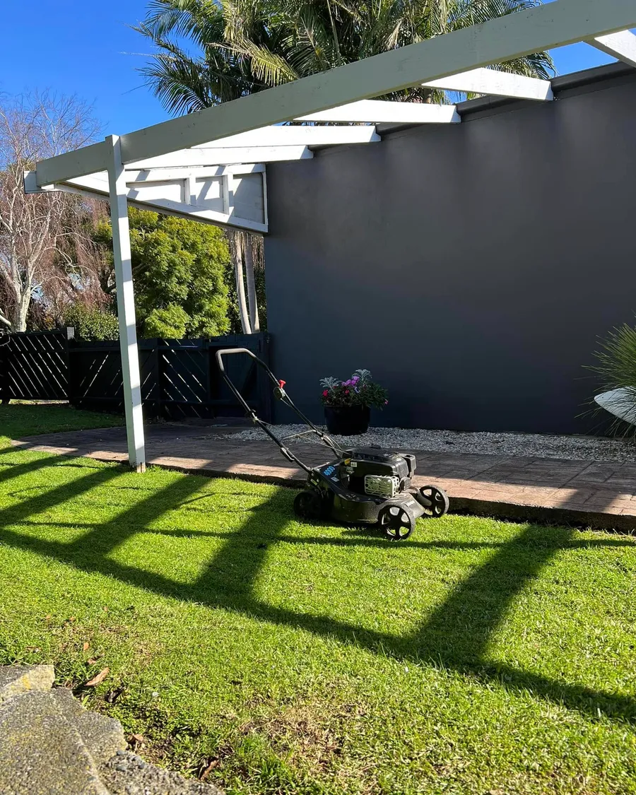 Freshly mowed back lawn under a white pergola