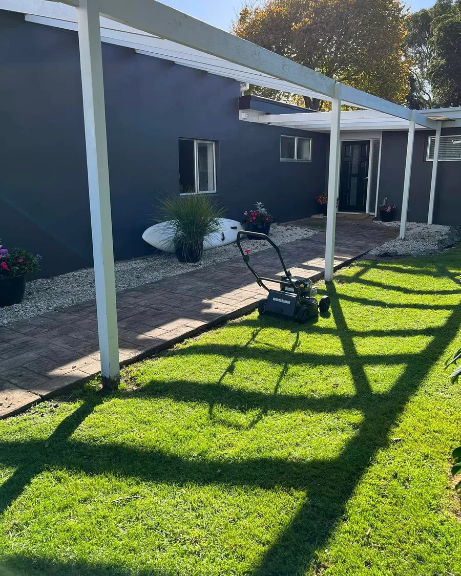 Freshly mowed lawn with neat edges along a brick path